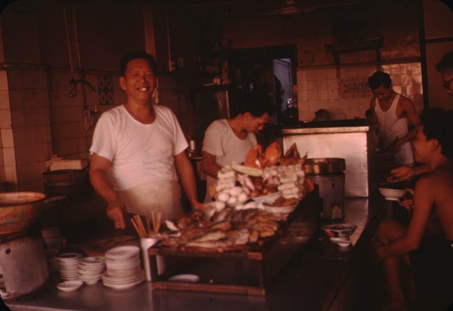A group of people cooking in a kitchen
Description automatically generated with medium confidence